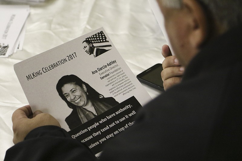Staff Photo by Dan Henry / The Chattanooga Times Free Press- 1/8/17. A Unity Group attendee looks at a M.L. King Celebration Day flyer while at Eastdale Village Community Methodist Church on Sunday, January 8, 2017.