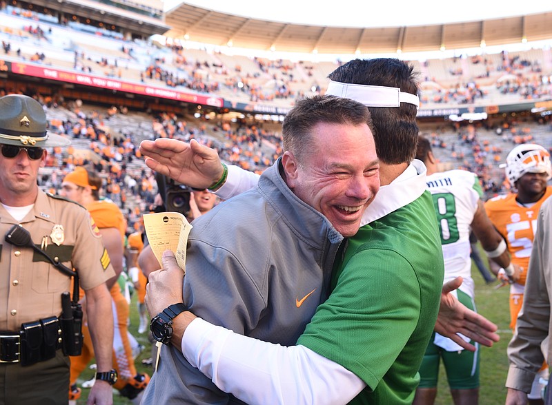 A smiling Butch Jones is embraced by North Texas Interim Head Coach Mike Canales following Tennessee's 24-0 win in Neyland Stadium.
