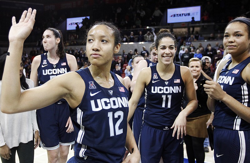 
              Connecticut guard Saniya Chong (12) and her teammates wave to fans after an NCAA college basketball game against SMU, Saturday, Jan. 14, 2017, in Dallas. Connecticut won 88-48, their 91st straight win. (AP Photo/Brandon Wade)
            