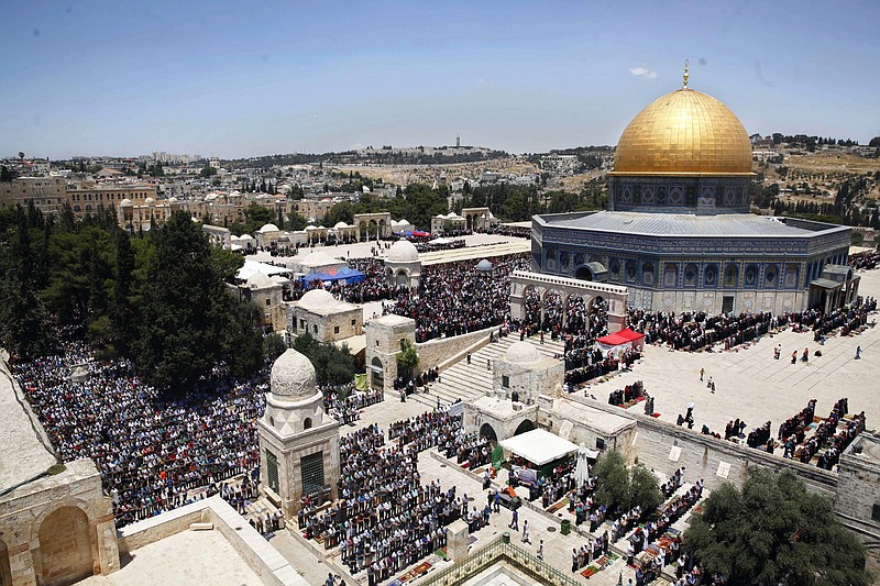 
              FILE - In this June 17, 2016 file photo, Palestinians pray in the Al Aqsa Mosque compound during the Muslim holy month of Ramadan, in Jerusalem's Old City. The Palestinians are ringing alarm bells over Donald Trump's stated intention to relocate the U.S. Embassy in Israel to contested Jerusalem, fearing quick action once he takes office as U.S. president next week. They say an embassy move would kill any hopes for negotiating an Israeli-Palestinian border deal and rile the region by undercutting Muslim and Christian claims to the holy city. (AP Photo/Mahmoud Illean, File)
            
