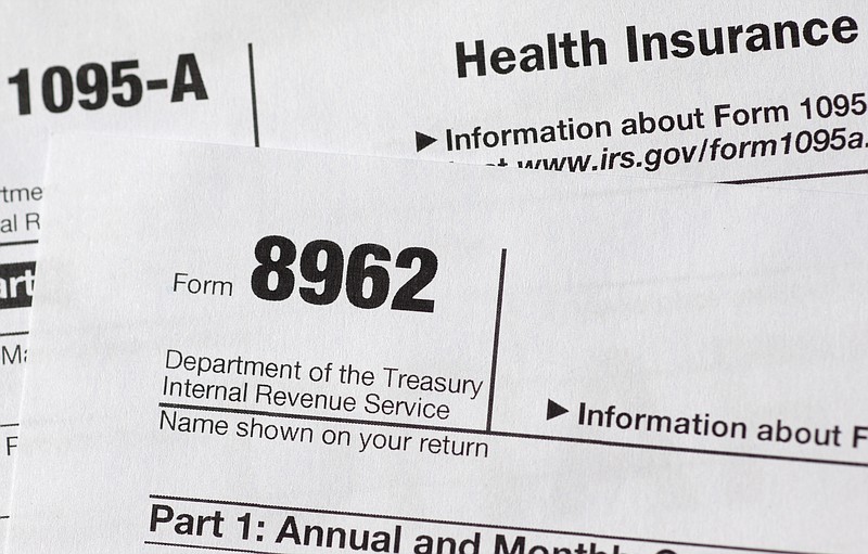 
              FILE - In this Aug. 21, 2014 file photo, tax form 8962 is seen in Washington. If you haven’t signed up for health insurance this year, you may be getting a nudge from the taxman. The IRS is sending personalized letters to millions of uninsured taxpayers that they’re potentially on the hook for hundreds of dollars in fines.  (AP Photo/Carolyn Kaster, File)
            