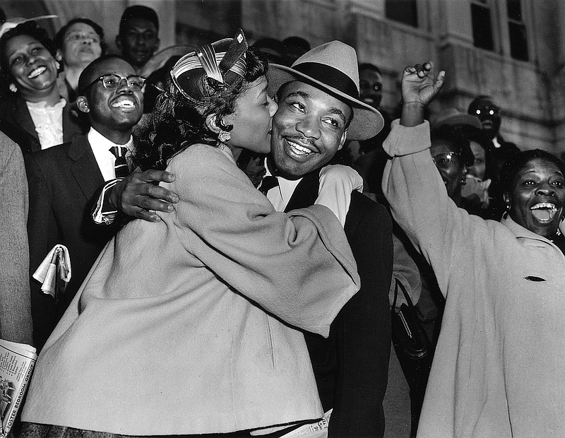 The Rev. Martin Luther King Jr. is welcomed with a kiss by his wife, Coretta, after leaving court in Montgomery, Ala., March 22, 1956.