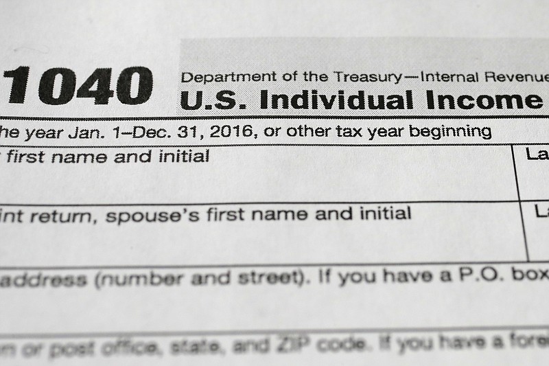 
              This Tuesday, Jan. 10, 2017, photo shows a 1040 tax form, in New York. The Internal Revenue Service says to expect a few changes when the nation’s individual income tax filing season opens on Jan. 23. (AP Photo/Mark Lennihan)
            