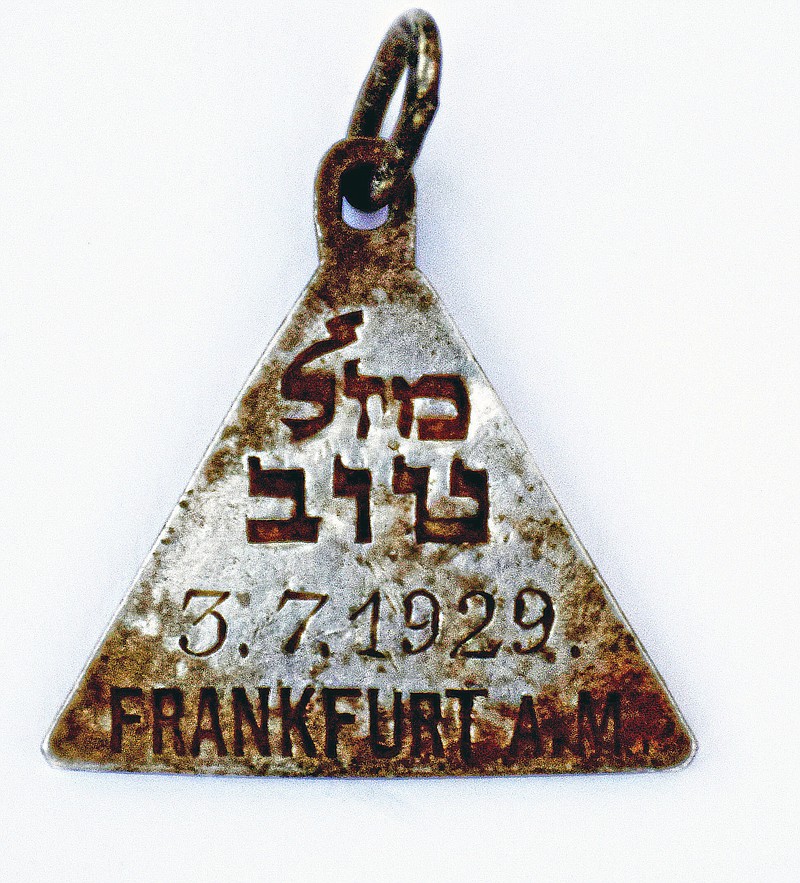 
              This undated photograph released by the Israel Antiquities Authority shows a pendant that appears identical to one belonging to Anne Frank, Israel's Yad Vashem Holocaust memorial said Sunday. Yad Vashem says it has ascertained the pendant belonged to Karoline Cohn _ a Jewish girl who perished at Sobibor and may have been connected to the famous diarist. Both were born in Frankfurt in 1929 and historians have found no other pendants like theirs. The triangular piece found has the words "Mazal Tov" written in Hebrew on one side along with Cohn's date of birth and the Hebrew letter "heh," an initial for God, as well as three Stars of David on the other. (Yoram Haimi, Israel Antiquities Authority via AP)
            