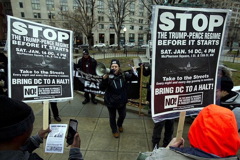 
              Demonstrators hold banners as they protest in opposition of President-elect Donald Trump, at McPherson Square, in Washington, Saturday, Jan. 14, 2017. ( AP Photo/Jose Luis Magana)
            