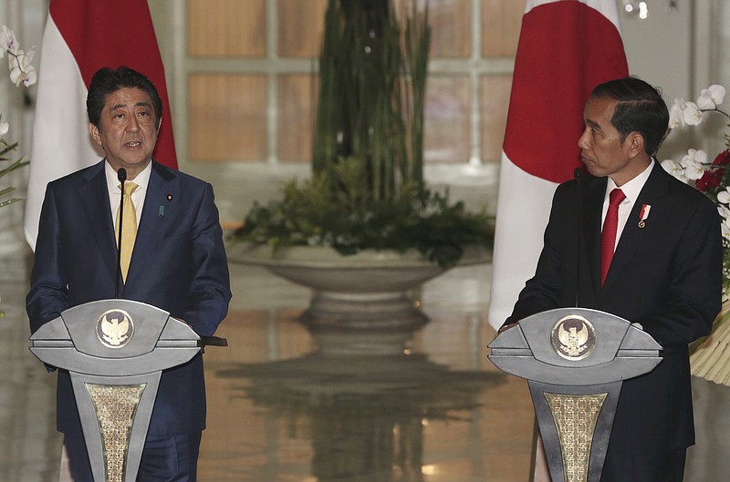 
              Japan's Prime Minister Shinzo Abe, left, talks to journalist during a joint press conference with Indonesian President Joko Widodo after a meeting at Presidential Palace in Bogor, West Java, Indonesia, Sunday, Jan. 15, 2017. (AP Photo/Achmad Ibrahim)
            
