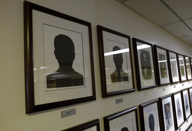 
              In a Jan 6, 2017 photo, a silhouette marks the empty frame for former Toledo mayor James Berdan during a reception to honor the 180th anniversary of the City of Toledo, featuring the historic "Portraits of Toledo Mayors", in Toledo, Ohio. A new display featuring the former mayors of Ohio’s fourth-largest city turned up a discovery: a photo thought to be of Berdan, Toledo’s first mayor, is actually a photo of his son.  (Jetta Fraser/The Blade via AP)
            