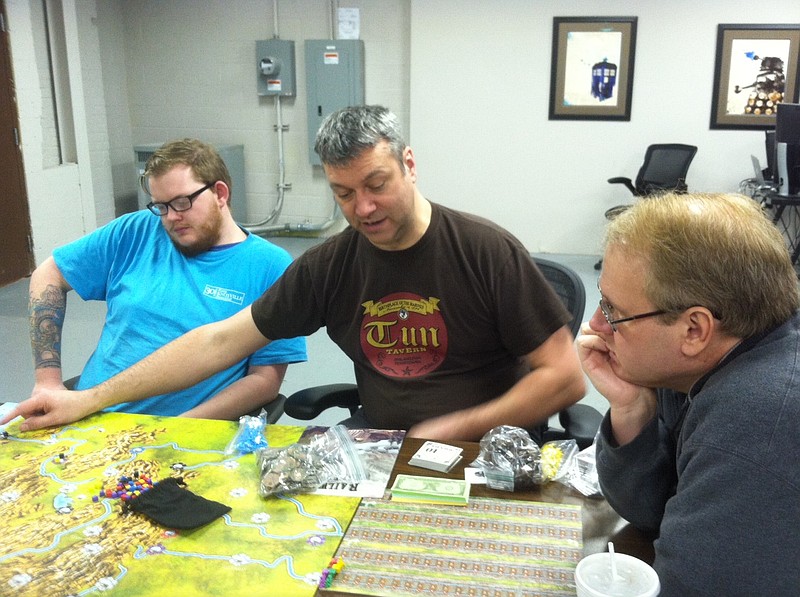 Chattanooga Board Game Club members Jesse Whitehead, Lee Walker and Bryan Chambers, from left, sit down for Tuesday game night, a regular event for the club. A usual event can bring between 12 to almost 30 people, Walker says, and everyone is welcome.