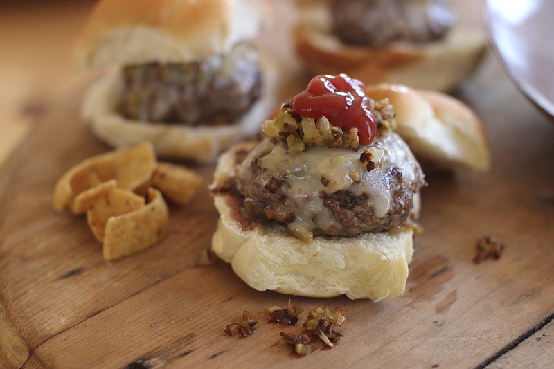 If you plan to serve a variety of dishes for the rest of the NFL season, sliders are more sensible than the full-sized guys. (AP Photo/Matthew Mead)
