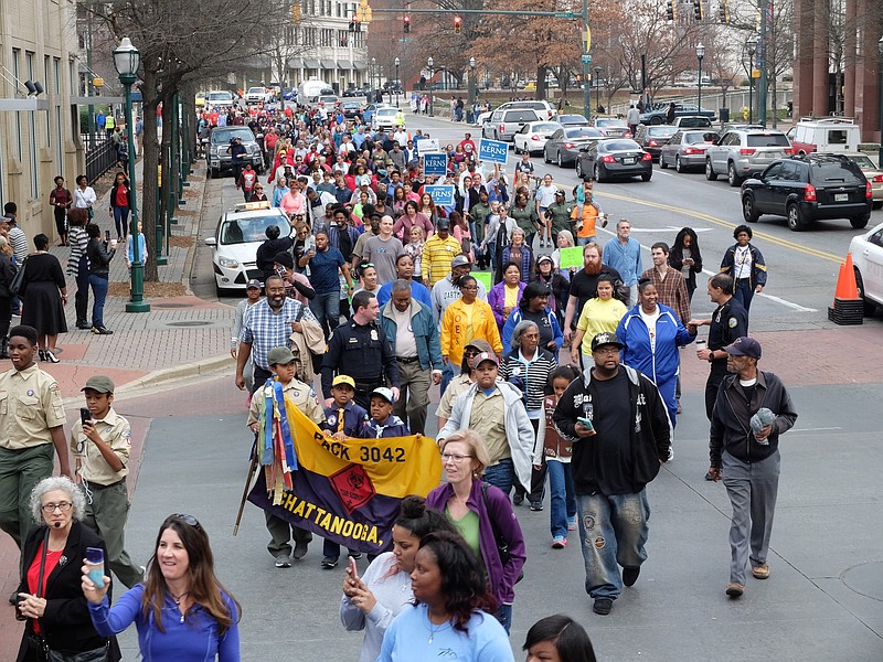 Hundreds of people march on M.L. King Blvd., then turn north on Broad Street to the Tivoli Theater in the annual King March in downtown Chattanooga.