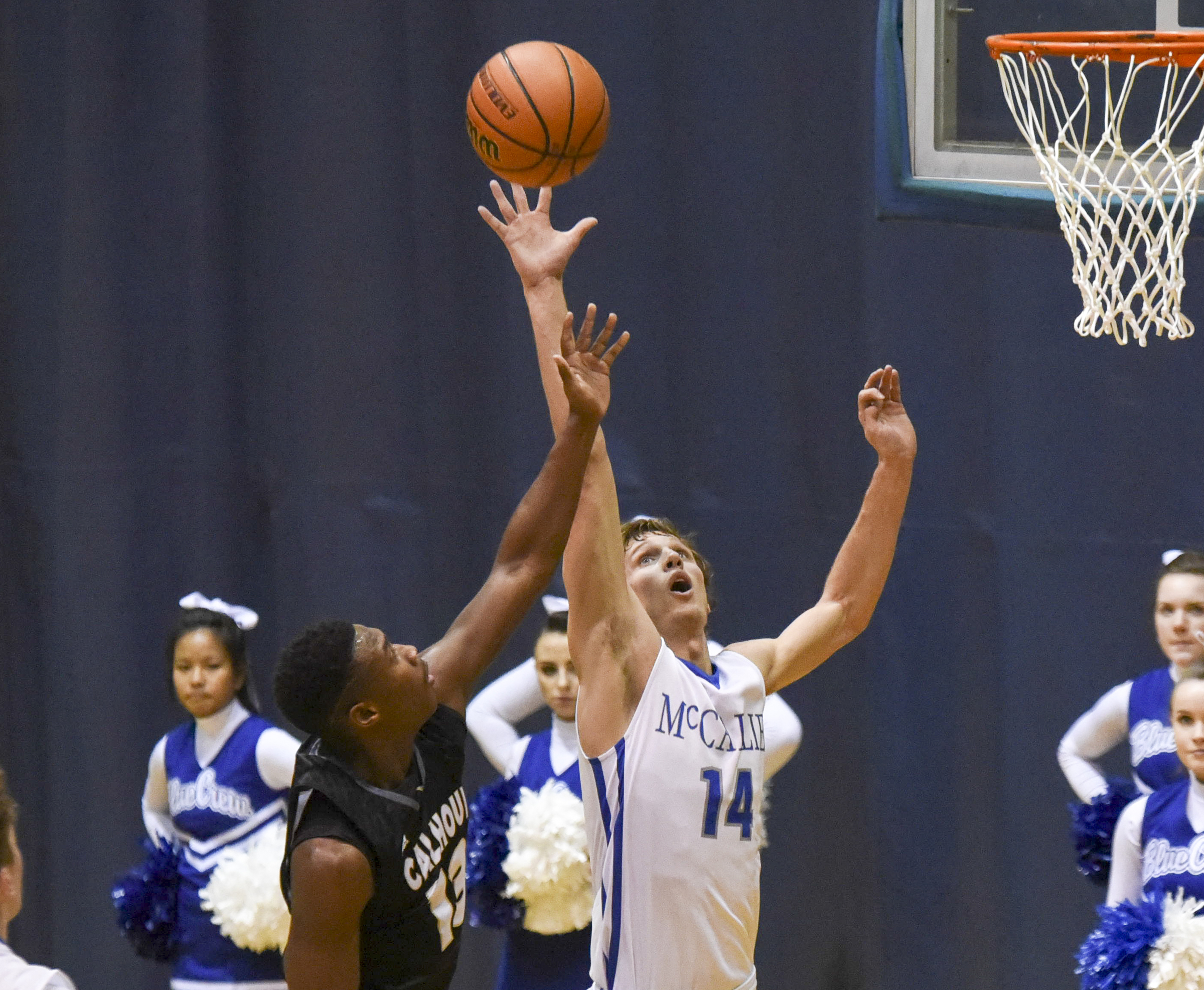 Calhoun's Malik Lawrence (13) has his shot redirected by McCallie's Seth Clark (14) in first half action in the King of the Courts tournament Monday night at Maclellan Gym.