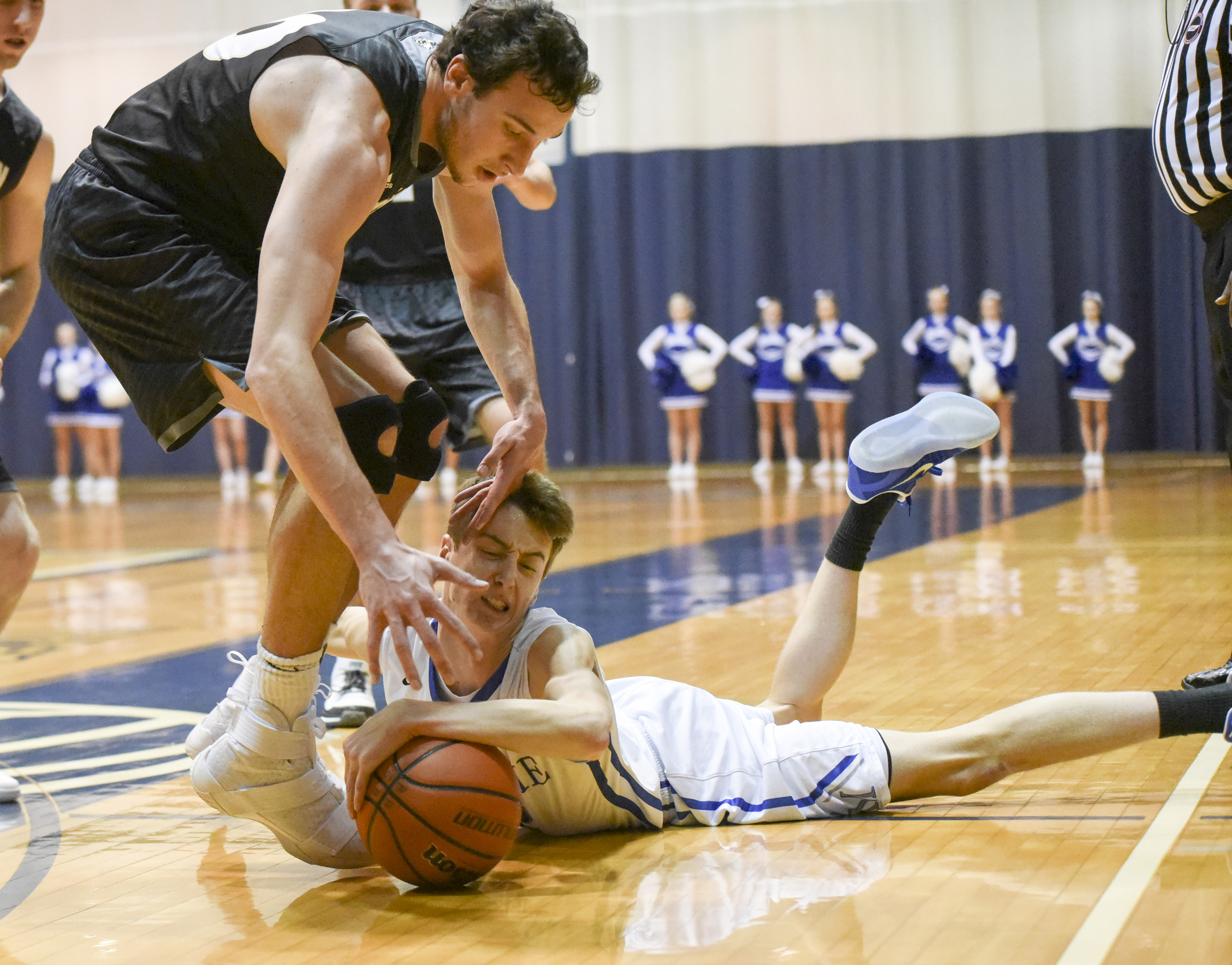 McCallie's Henley Edge tackles the ball at the feet of Calhoun's Chapin Rierson during first half action in the King of the Courts tournament Monday night at Maclellan Gym.
