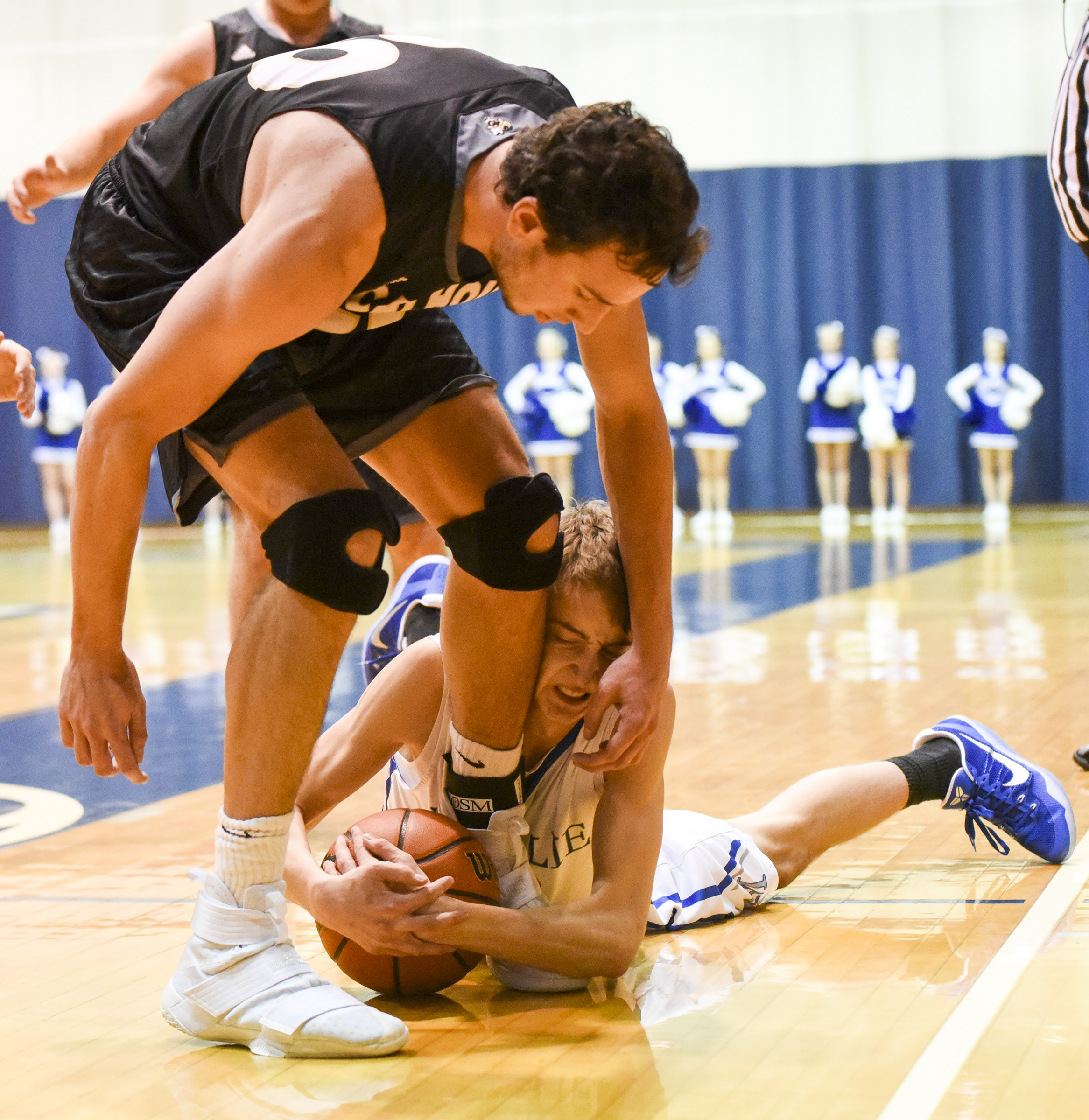 McCallie's Henley Edge tackles the ball at the feet of Calhoun's Chapin Rierson during first half action in the King of the Courts tournament Monday night at Maclellan Gym.