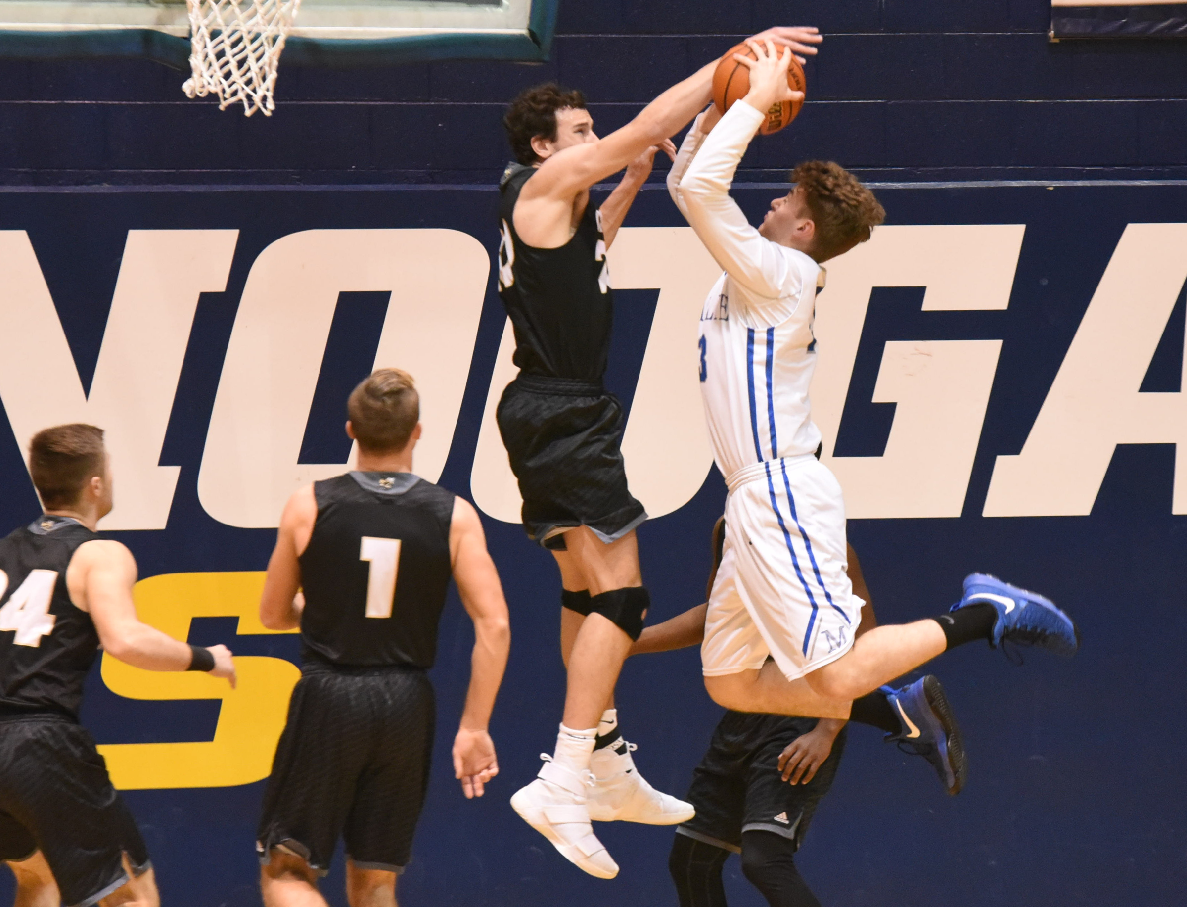 Calhoun's Chapin Rierson, left, makes a block attempt on McCallie's Max Shulman in first half action Monday night in the King of the Courts tournament at Maclellan Gym.