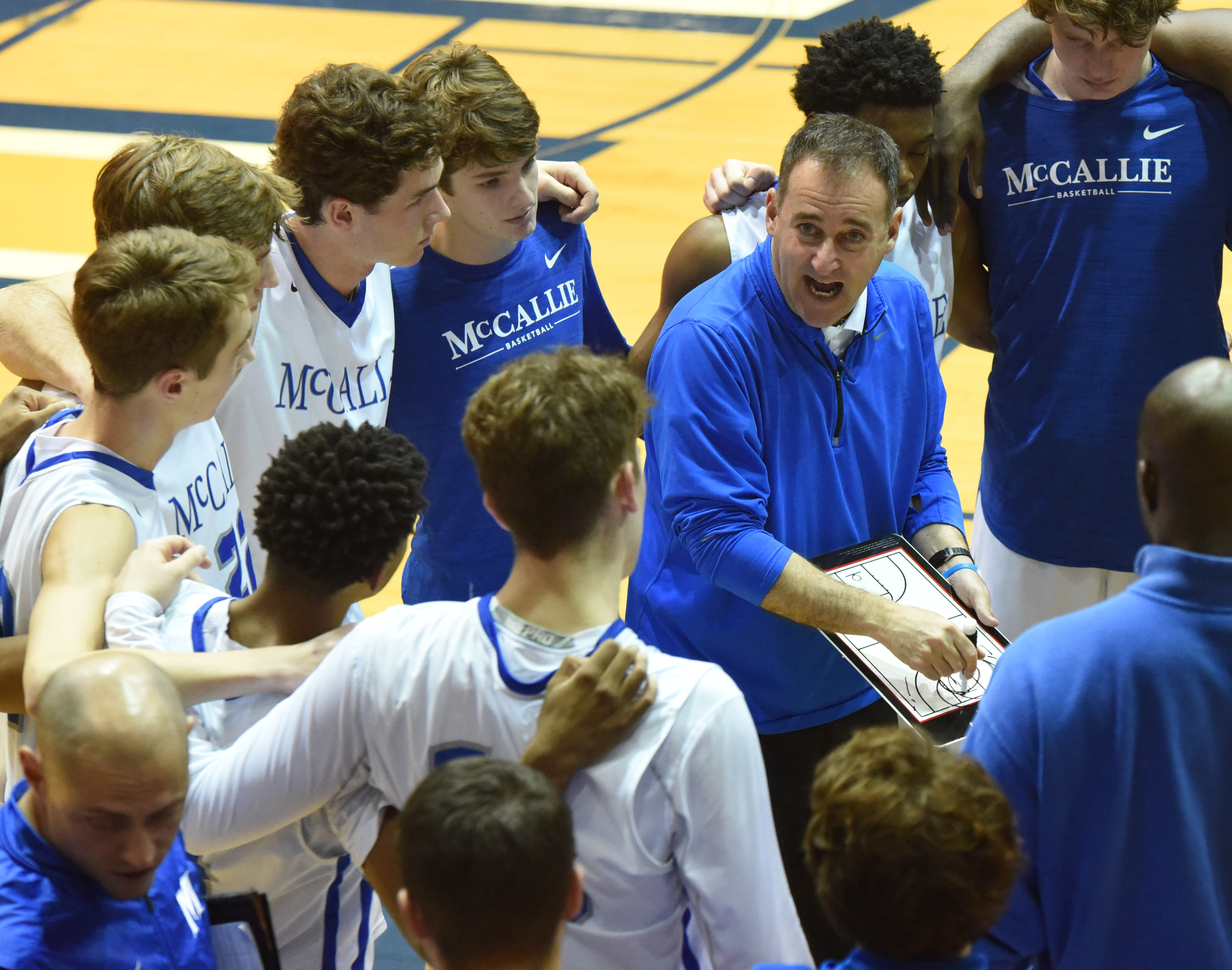 McCallie coach John Shulman instructs his team during a timeout in the King of the Courts tournament Monday night at Maclellan Gym.