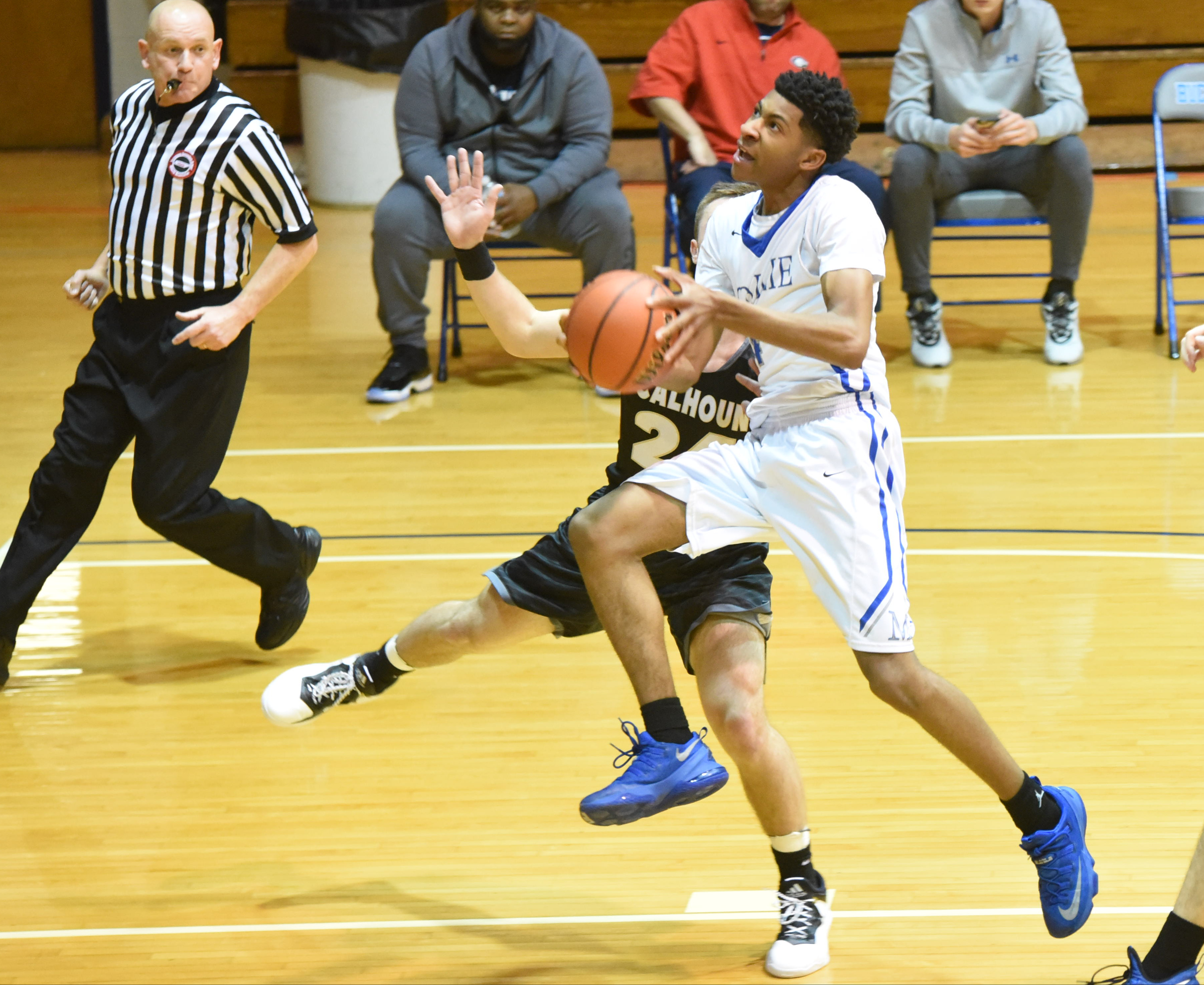McCallie's Jr. Clay avoids Calhoun's Ryan Randall on the way up in the King of the Courts tournament earlier this season at Maclellan Gym.