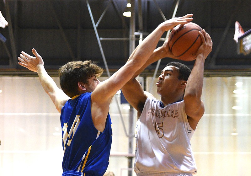 Chattanooga Christian's Ben Moore is guarded by Boyd Buchanan's Max Walker Monday, January 16, 2016 in the King of the Courts tournament at the University of Tennessee at Chattanooga's Maclellan Gym.
