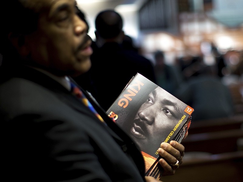 
              James R. Johnson hands out programs before the Rev. Martin Luther King Jr. holiday commemorative service at Ebenezer Baptist Church, Monday, Jan. 16, 2017, in Atlanta. (AP Photo/Branden Camp)
            