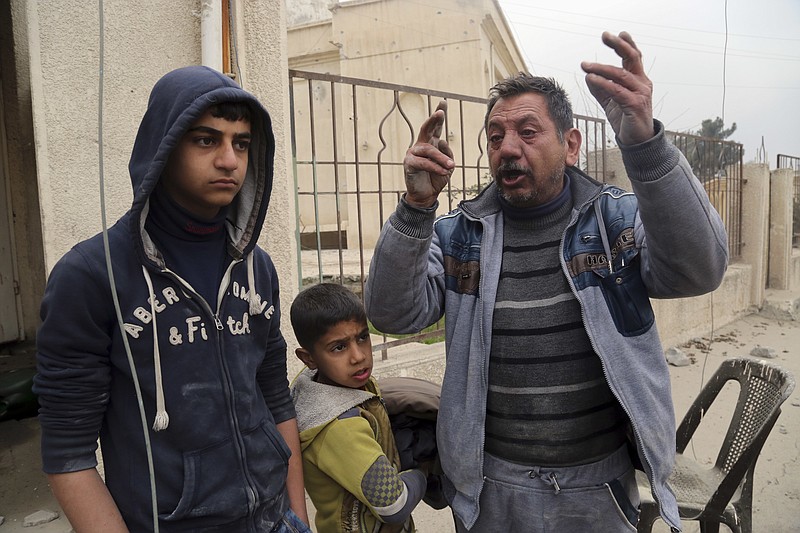 
              Thanon Yunus Yahya, right, chant slogans against Islamic State militia in a neighborhood recently liberated from the militia on the eastern side of Mosul, Iraq, Sunday, Jan. 15, 2017. Yahya claimed that his wife and son were previously executed by Islamic State militia. (AP Photo/ Khalid Mohammed)
            