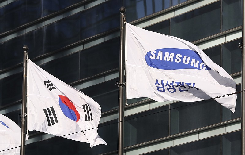 
              The company flag of Samsung Electronics flutters next to the South Korean national flag in Seoul, South Korea, Monday, Jan. 16, 2017. Prosecutors requested the arrest Monday of the de facto head of Samsung, South Korea's biggest company, on bribery and other charges in the influence-peddling scandal that led to the impeachment of the country's president. (AP Photo/Lee Jin-man)
            