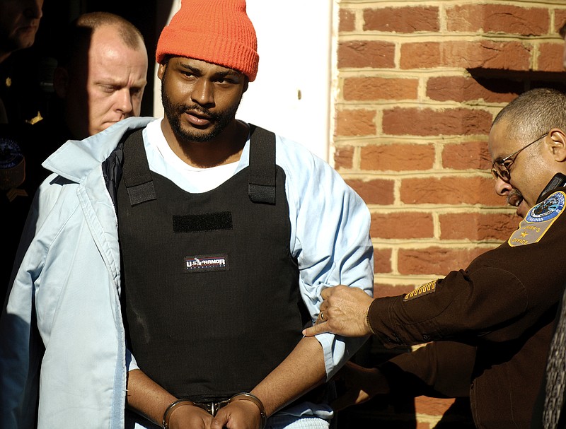 
              FILE - In this Jan. 3, 2007, file photo, Ricky Gray is escorted from the county courthouse in Culpeper, Va. Gray is scheduled to be put to death on Jan. 18, 2017 for the 2006 murders of Stella Harvey and Ruby. The girls and their parents, Bryan and Kathryn Harvey, were found in the basement of their burning home, bound, beaten and stabbed, with their throats cut. (Mike Morones/The Free Lance-Star via AP, File)
            