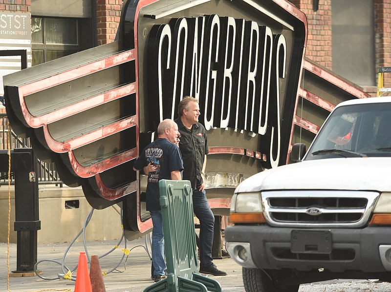 David Davidson, left, COO and Curator of Songbirds, and Johnny Smith, President of Songbirds Timeless Guitars, stand in front of the new sign before erecting on the historic Chattanooga Choo-Choo building in downtown Chattanooga on Thursday, Nov. 3, 2016.