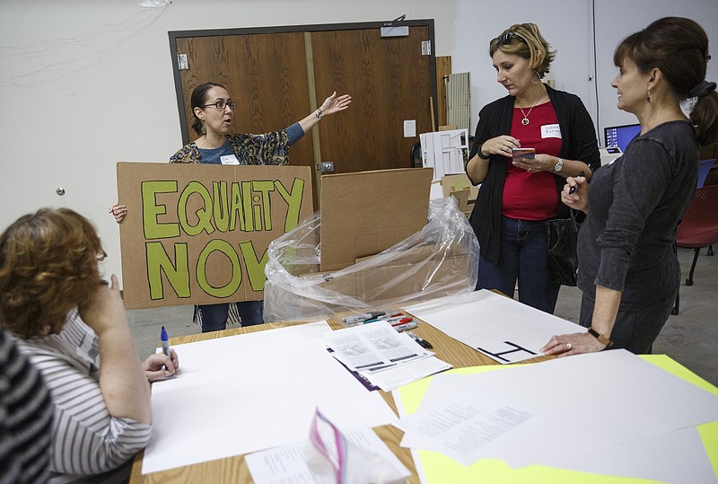 Lisa Bellino, left, gives guidelines to Leanne Barron, center, and Colleen Colton during a recent sign-making session at the Chattanooga Public Library in preparation for the Women's March on Washington on Saturday, Jan. 21. Marches in Chattanooga and Mentone, Ala., will coincide with the national march.
