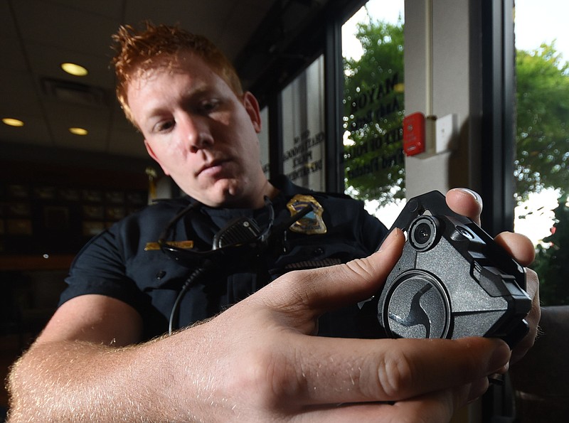 Chattanooga Police Officer Hunter Morgan attaches his personal body camera to a uniform clip that mounts on his chest during a 2016 test of the cameras.