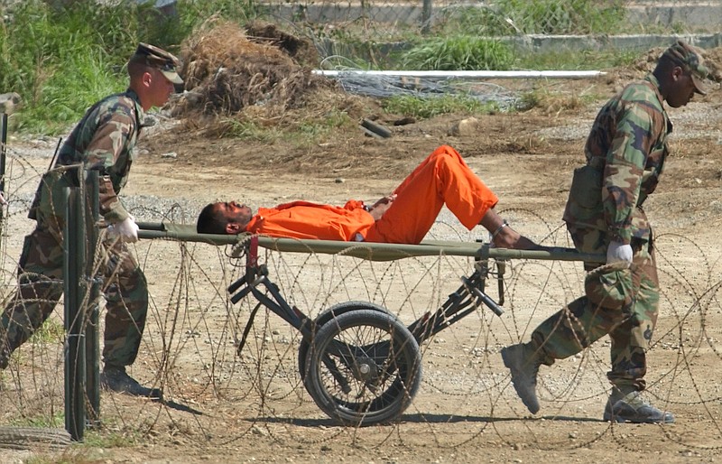 
              FILE - In this Feb. 2, 2002 file photo, a detainee from Afghanistan is carried on a stretcher before being interrogated by military officials at the detention facility Camp X-Ray on Guantanamo Bay U.S. Naval Base in Cuba. The White House said Tuesday, Jan. 17, 2017 that the detention center will still be open when President Barack Obama leaves office, conceding that a core campaign promise will go unfulfilled. (AP Photo/Lynne Sladky, File)
            