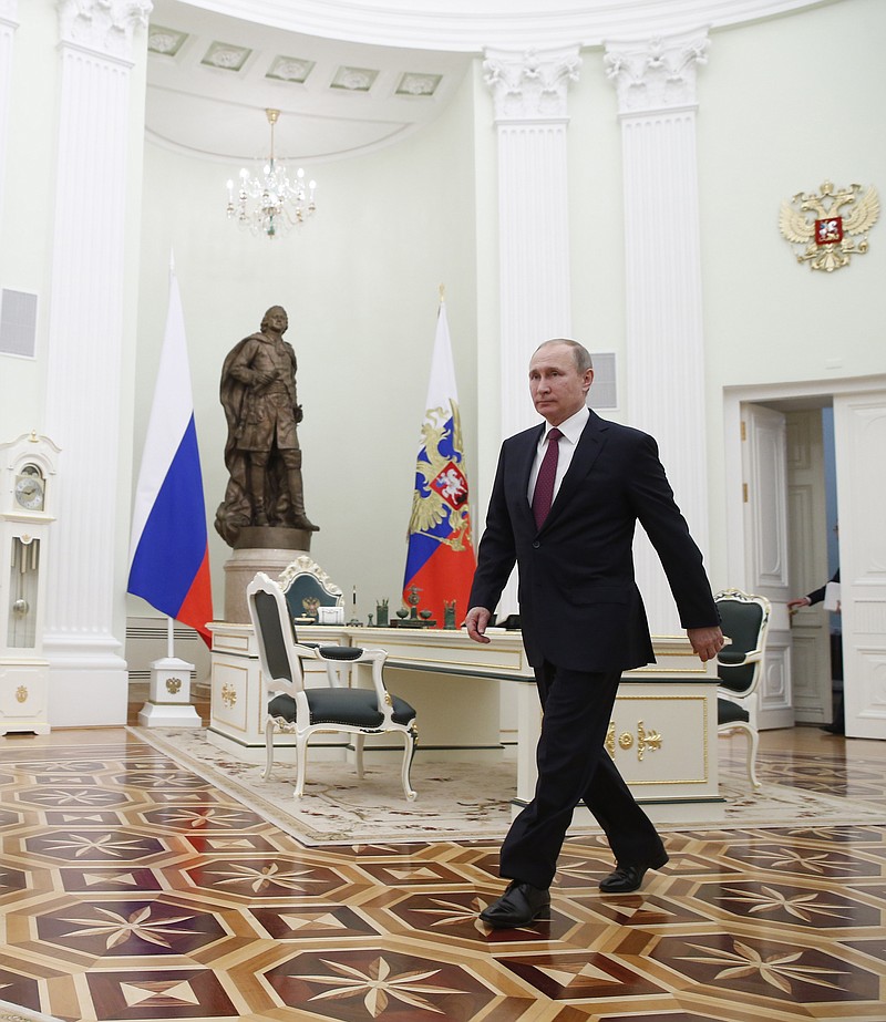 
              Russian President Vladimir Putin walks to meet with Moldovan President Igor Dodon in Moscow's, Kremlin, Russia, Tuesday, Jan. 17, 2017. Dodson is in Russia on an official visit. (Sergei Ilnitsky/Pool photo via AP)
            