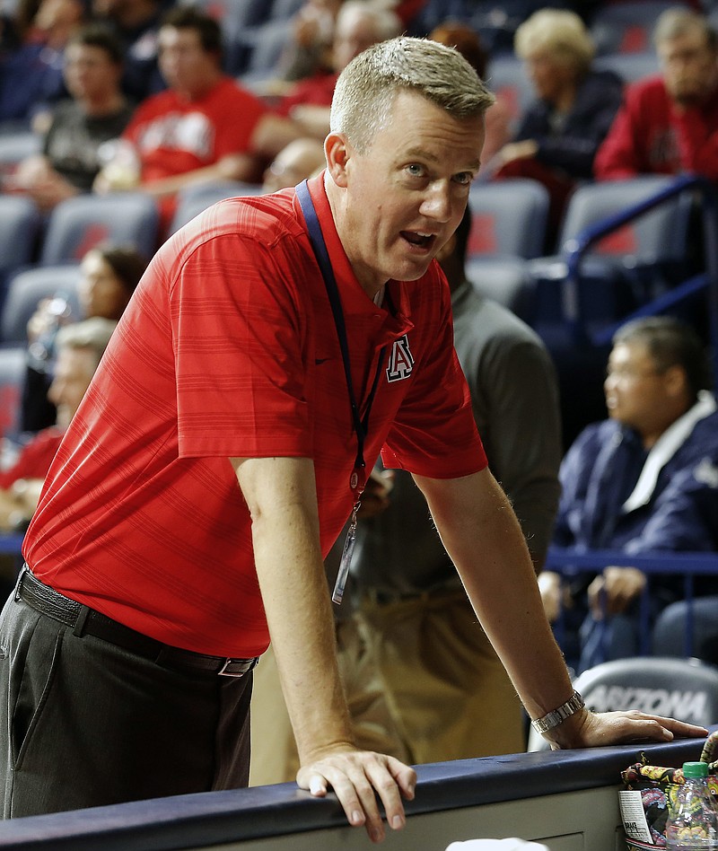 This is a Dec. 2, 2014, file photo showing Greg Byrne, Arizona Vice President for Athletics, during the first half of an NCAA college basketball game between Arizona against Gardner Webb, in Tucson, Ariz. Alabama is hiring Greg Byrne to replace retiring athletic director Bill Battle. The university announced Monday, jan. 16, 2017, that Byrne will take over March 1. The hire needs approval from Alabama trustees. (AP Photo/Rick Scuteri, File)