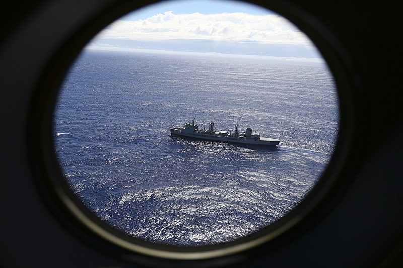 
              FILE - In this March 31, 2014 file photo, HMAS Success scans the southern Indian Ocean, near the coast of Western Australia, as a Royal New Zealand Air Force P3 Orion flies over, while searching for missing Malaysia Airlines Flight MH370. After nearly three years, the hunt for Malaysia Airlines Flight 370 ended in futility and frustration on Tuesday, Jan. 17, 2017, as crews completed their deep-sea search of a desolate stretch of the Indian Ocean without finding a single trace of the plane. (AP Photo/Rob Griffith, File)
            