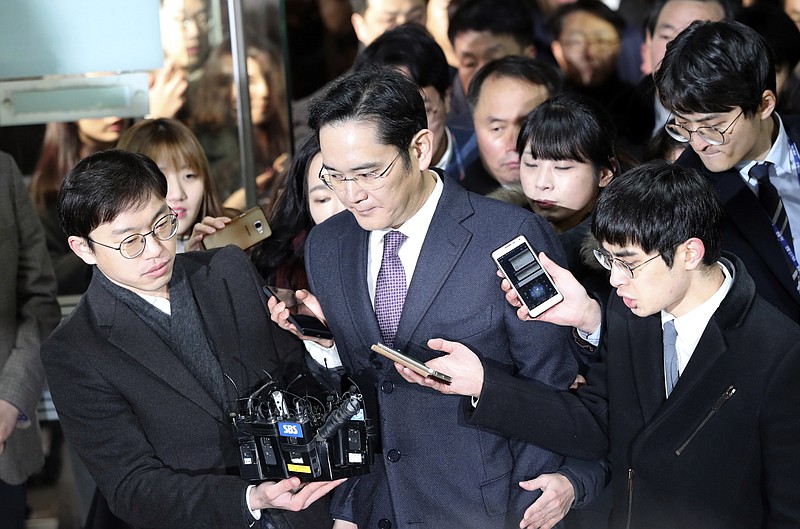 
              Lee Jae-yong, center, a vice chairman of Samsung Electronics Co. is questioned by reporters upon his arrival at the Seoul Central District Court in Seoul, South Korea, for a hearing Wednesday, Jan. 18, 2017.  The Seoul Central District Court will decide whether to arrest Lee after prosecutors requested the arrest earlier this week. (AP Photo/Lee Jin-man)
            