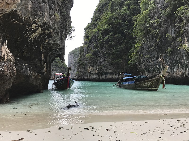 Long-tail boats sit near a small beach on Ko Phi Phi Leh, an island off the southwestern coast of Thailand. The smaller of the Phi Phi Islands is a tourist hotspot for its beautiful water, party atmosphere and famed Maya Bay, where the movie "The Beach" was filmed.