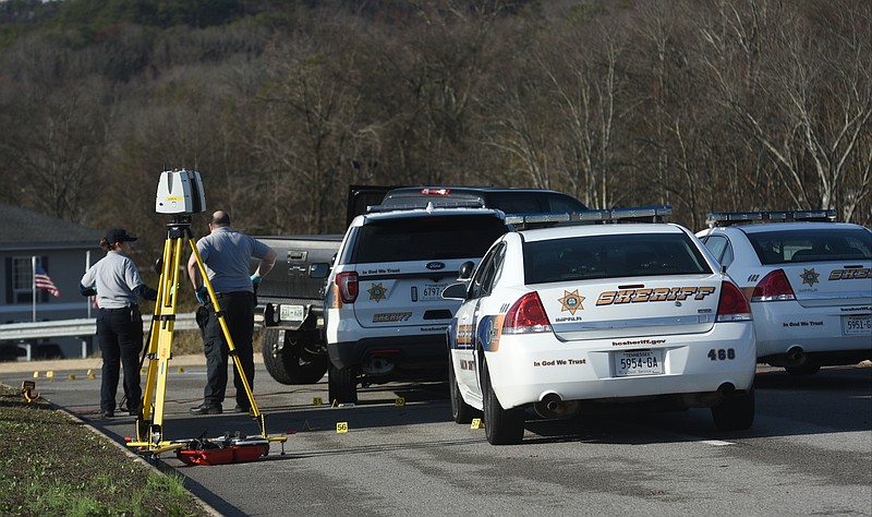 Officers investigate the scene Wednesday, January 18, 2017 where a suspect was fatally shot by Hamilton County deputies after a vehicle pursuit ended Tuesday night at the 200 block of Sequoyah-Access Road in Soddy-Daisy.  