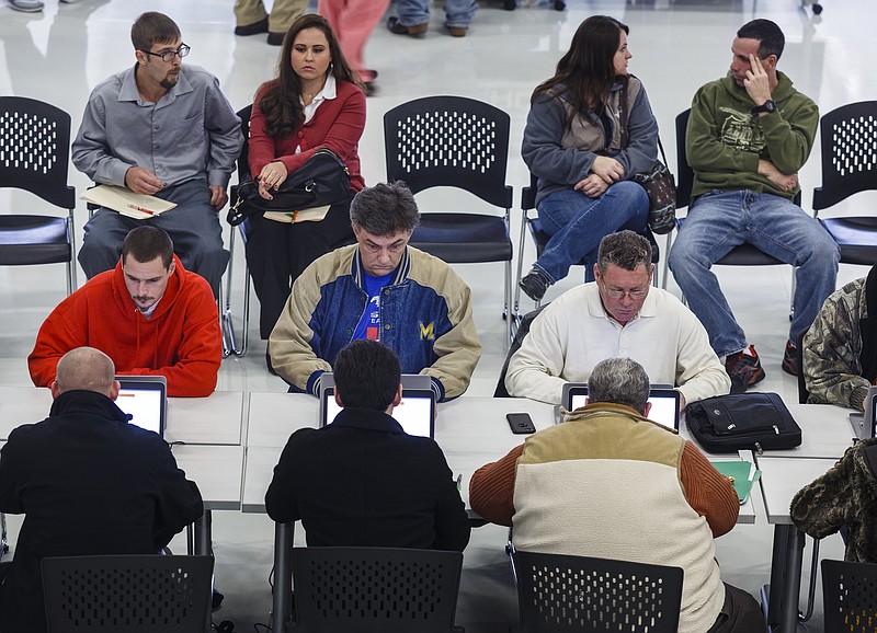 Job-seekers apply during a job fair with Volkswagen staffing contractor Aerotek held at the Volkswagen Manufacturing Plant on Friday, Dec. 16, 2016, in Chattanooga, Tenn. Aerotek is hiring to fill production slots for manufacturing Volkswagen's new Atlas SUV.