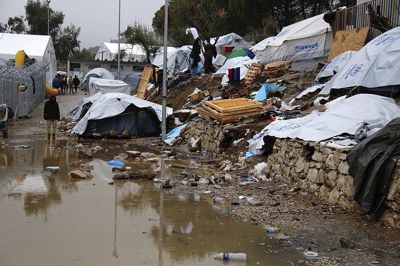 
              FILE - In this Tuesday, Jan. 10, 2017 file photo, arefugee stands next to a pool of mud at Moria refugee camp on the eastern Greek island of Lesbos. Europe's top official for migration on Wednesday, Jan. 18, 2017 deplored the plight of thousands of refugees and other migrants in camps on Greece's eastern Aegean island of Lesbos who face harsh winter conditions. Dimitris Avramopoulos, the European Union's commissioner for migration, said solutions must be found immediately. (Petros Tsakmakis/InTime News via AP, file)
            