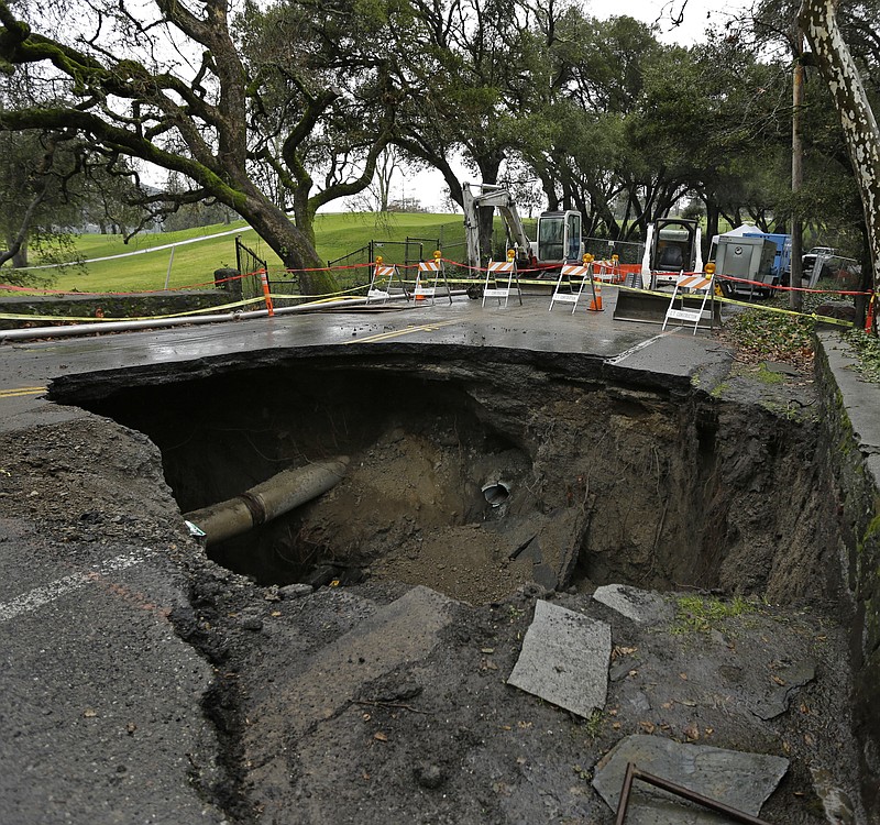 
              A 72-inch deep sinkhole is seen Wednesday, Jan. 18, 2017, in Orinda, Calif. The city council of Orinda declared a State of Emergency Tuesday night because of a large sinkhole caused by last week's wet weather, which ruptured two sewer lines. Repairs will take at least four weeks, as the San Francisco Bay Area is being hit with a new series of rain storms. (AP Photo/Ben Margot)
            