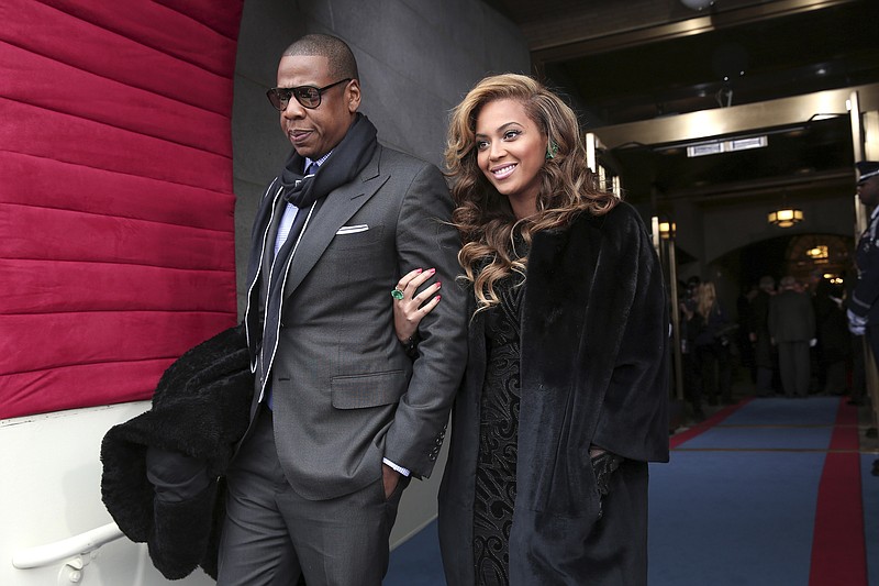
              FILE - This Jan. 21, 2013 file photo shows recording artists Jay-Z and Beyonce arriving on the West Front of the Capitol in Washington for the Presidential Barack Obama's ceremonial swearing-in ceremony during the 57th Presidential Inauguration. President Barack Obama embraced hip-hop more than any of his predecessors. He once referenced Jay Z's lyrics, released his music playlist including several rappers from Chance the Rapper to Lil Wayne and was caught dancing to Drake's "Hot Line Bling" at a White House event. (AP Photo/Win McNamee, Pool)
            