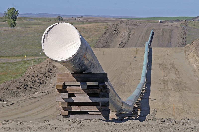 This Sept. 29, 2016 file photo, shows a section of the Dakota Access Pipeline under construction near the town of St. Anthony in Morton County, N.D. Texas-based Energy Transfer Partners, the company building the oil pipeline, asked a a federal judge on Tuesday, Jan. 17, 2017, to block the U.S. Army Corps of Engineers from launching a full environmental study of the $3.8 billion pipeline's disputed crossing of a Missouri River reservoir in North Dakota. (Tom Stromme/The Bismarck Tribune via AP, File)