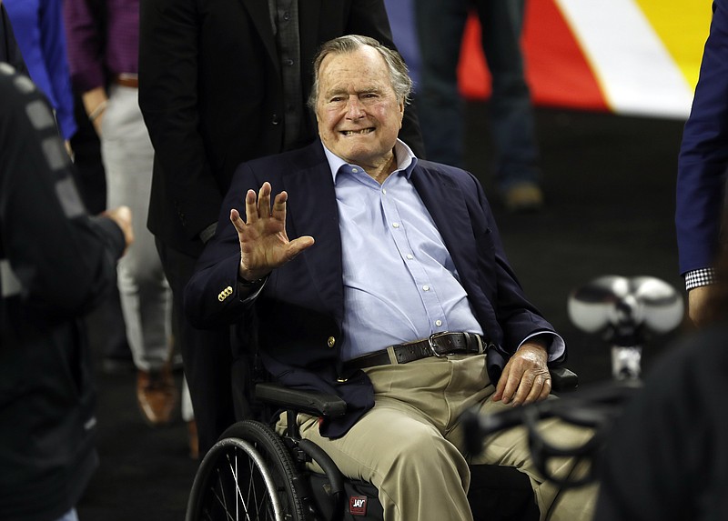 In this April 2, 2016, file photo, former President George H. W. Bush waves as he arrives at NRG Stadium before the NCAA Final Four tournament college basketball semifinal game between Villanova and Oklahoma in Houston. Houston-area media are quoting former President George H.W. Bush's chief of staff as saying that Bush has been hospitalized in Houston. (AP Photo/David J. Phillip, File)