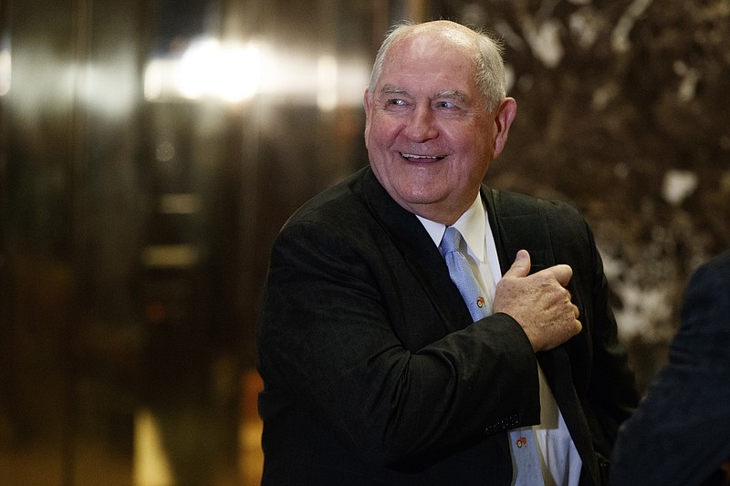 In this Nov. 30, 2016, file photo, former Georgia Gov. Sonny Perdue smiles as he waits for an elevator in the lobby of Trump Tower in New York. A person familiar with the decision says President-elect Donald Trump has chosen Perdue to serve as agriculture secretary. (AP Photo/Evan Vucci, File)