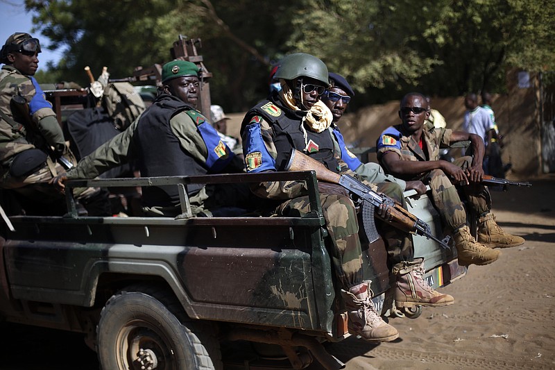 
              FILE - In this file photo taken on Sunday Nov. 24, 2013, the Malian army patrol the streets of Gao, Northern Mali. A doctor in northern Mali says Wednesday, Jan. 18, 2017 that at least seven people have been killed and more than 50 wounded in an attack on an installation for various armed groups, and the toll is certain to rise. (AP Photo/Jerome Delay, File)
            