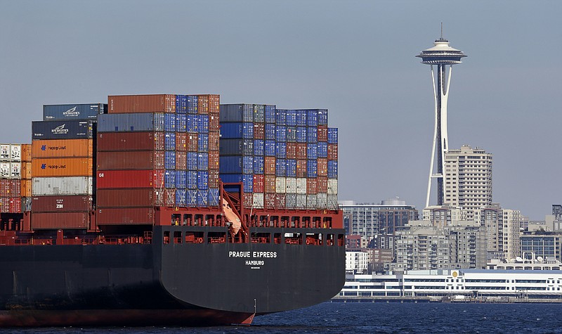 
              FILE - In this Feb. 15, 2015, file photo, the Space Needle towers in the background beyond a container ship anchored in Elliott Bay near downtown Seattle. A board member of the American Chamber of Commerce in China, Lester Ross, says China is preparing to retaliate if U.S. President-elect Donald Trump carries out promises to impose sanctions on Chinese goods. (AP Photo/Elaine Thompson, File)
            