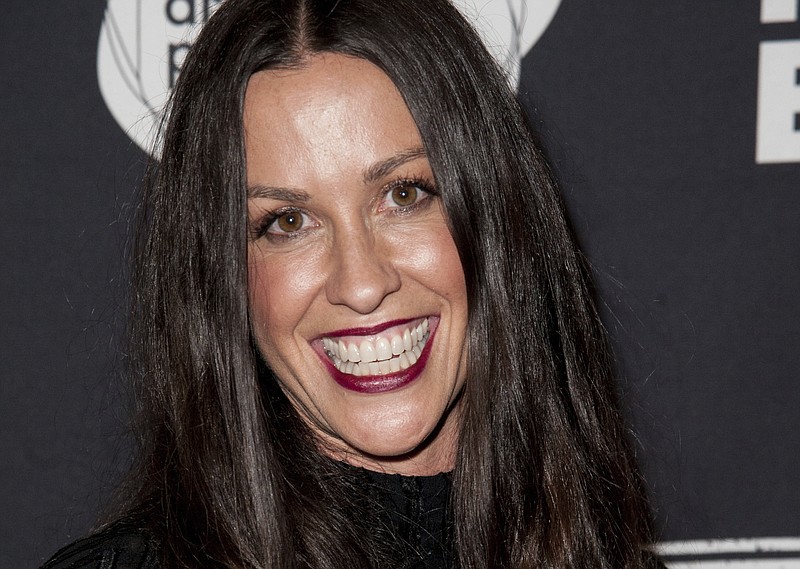 
              FILE - This June 20, 2014 file photo Alanis Morissette arrives at the 4th Annual Production Of The 24 Hour Plays After-Party in Santa Monica, Calif. Federal prosecutors say a business manager who embezzled more than $6.5 million from Morissette and other entertainment and sports figures has agreed to plead guilty. Jonathan Todd Schwartz agreed Wednesday, Jan. 18, 2017 to plead guilty in Los Angeles federal court to two felonies that carry a maximum of 23 years in federal prison. (Photo by Richard Shotwell/Invision/AP,File)
            