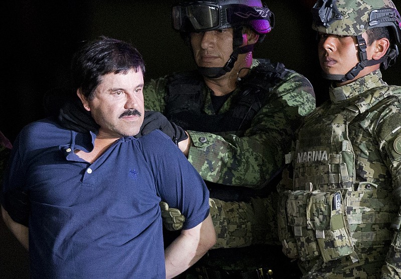 
              FILE - In this Jan. 8, 2016 file photo, a handcuffed Joaquin "El Chapo" Guzman is made to face the press as he is escorted to a helicopter by Mexican soldiers and marines at a federal hangar in Mexico City. According to Mexico's Foreign Ministry, Guzman has been extradited to the United States on Thursday, Jan. 19 2017.  (AP Photo/Eduardo Verdugo, File)
            