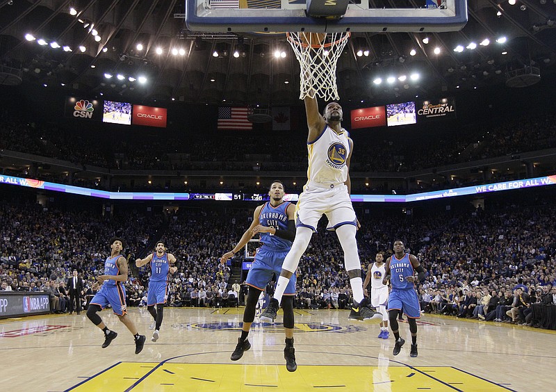
              Golden State Warriors' Kevin Durant (35) drives for a dunk attempt past Oklahoma City Thunder's Andre Roberson, center left, during the first half of an NBA basketball game Wednesday, Jan. 18, 2017, in Oakland, Calif. (AP Photo/Marcio Jose Sanchez)
            