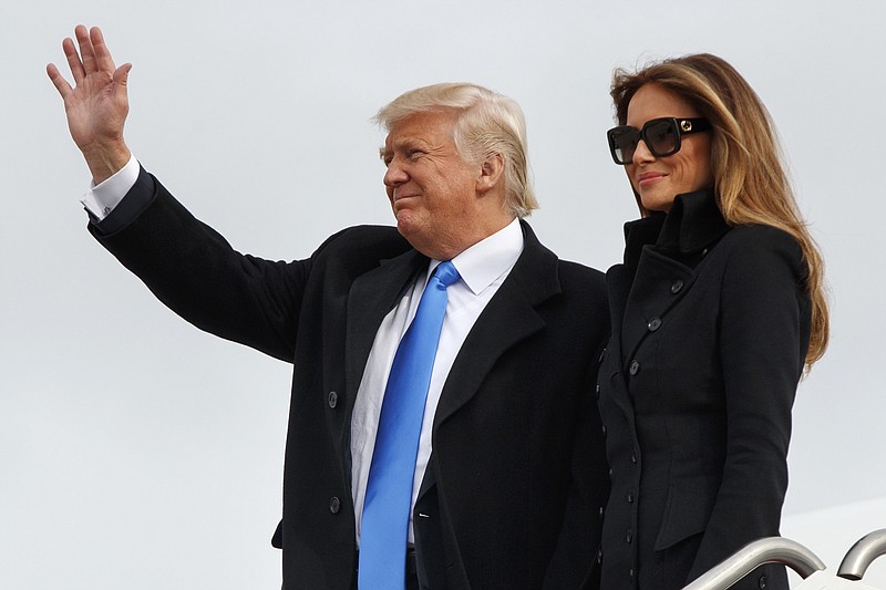 
              President-elect Donald Trump, accompanied by his wife Melania Trump, waves as they arrive at Andrews Air Force Base, Md., Thursday, Jan. 19, 2017, ahead of Friday's inauguration. (AP Photo/Evan Vucci)
            