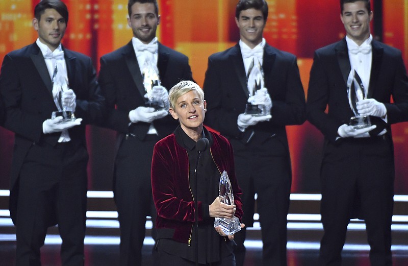
              Ellen DeGeneres, winner of the awards for favorite animated movie voice, favorite daytime TV host, and favorite comedic collaboration, speaks on stage at the People's Choice Awards at the Microsoft Theater on Wednesday, Jan. 18, 2017, in Los Angeles. Pictured in the background are DeGeneres' previous People's Choice awards, making her the most decorated People's Choice Award winner in the show's history. (Photo by Vince Bucci/Invision/AP)
            
