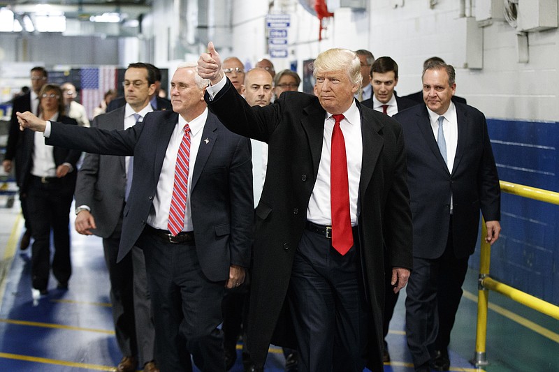 
              FILE - In this Dec. 1, 2016, file photo, President-elect Donald Trump and Vice President-elect Mike Pence wave as they visit to Carrier factory in Indianapolis, Ind. Donald Trump enters the White House on Jan. 20 just as he entered the race for president: defiant, unfiltered, unbound by tradition and utterly confident in his chosen course. In the 10 weeks since his surprise election as the nation’s 45th president, Trump has violated decades of established diplomatic protocol, sent shockwaves through business boardrooms, tested long-standing ethics rules and continued his combative style of replying to any slight with a personal attack _ on Twitter and in person. (AP Photo/Evan Vucci, File)
            